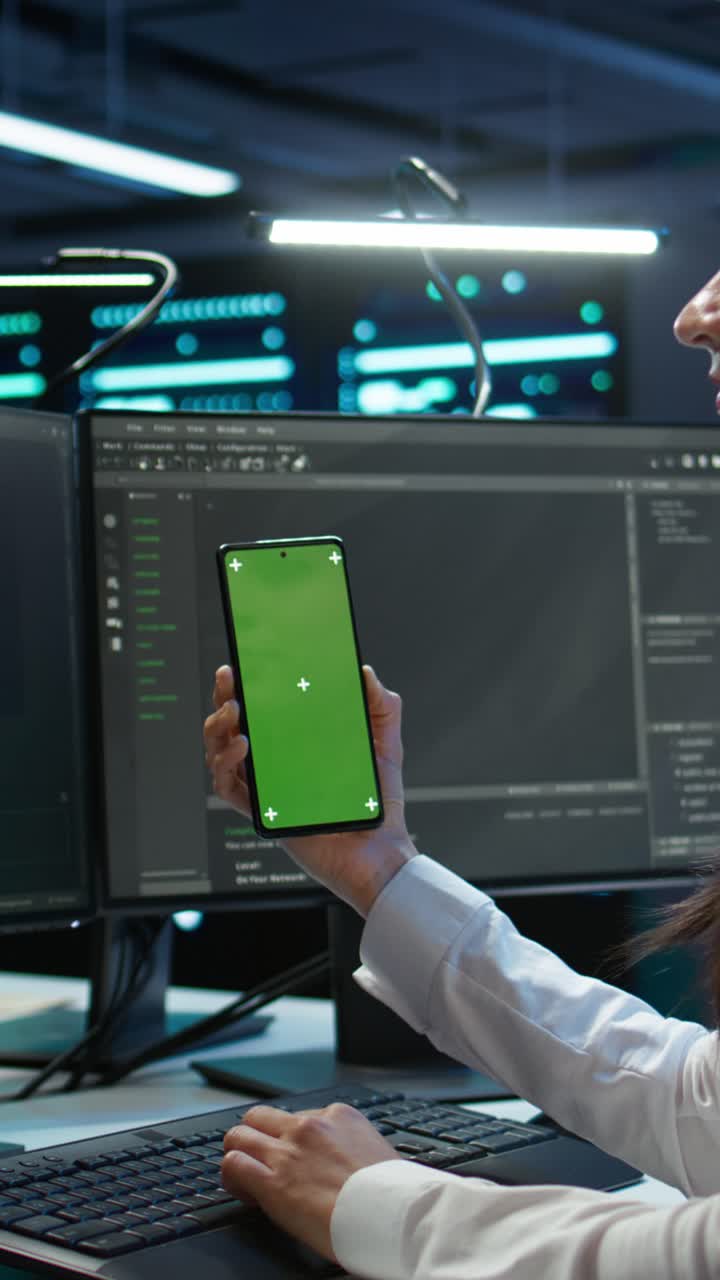 Woman Programmer Holding Green Screen Smartphone While Coding