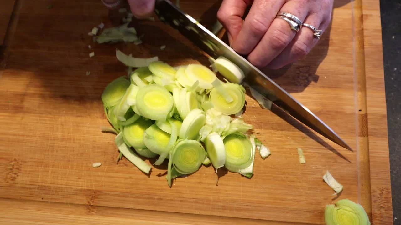 Cutting leek on a wooden board