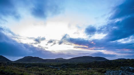 time lapse of dark clouds over volcanic landscape at the base of geldingadalir volcano, iceland - zoom in