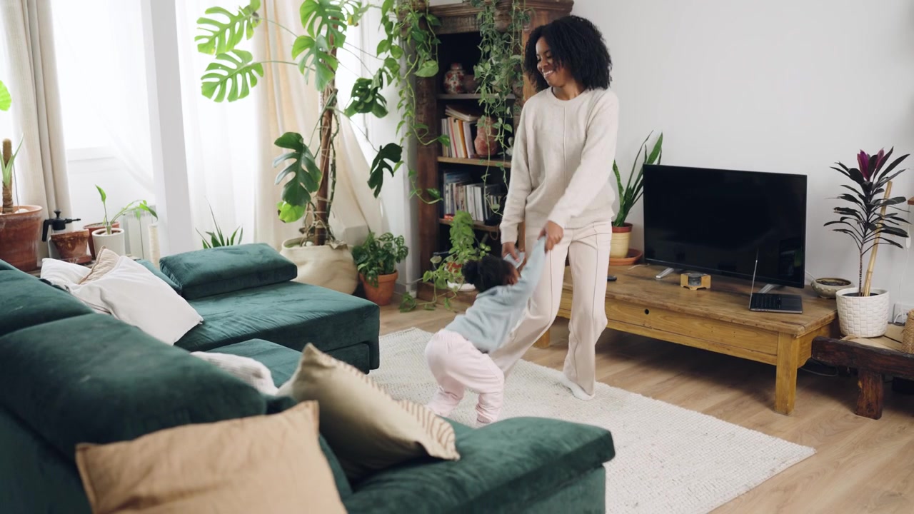 Happy African American Mother and Daughter Playing in Living Room