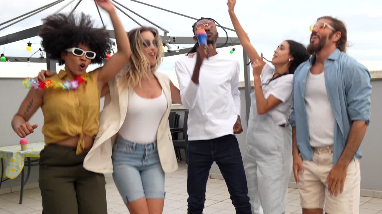 A group of people celebrating and dancing on a rooftop