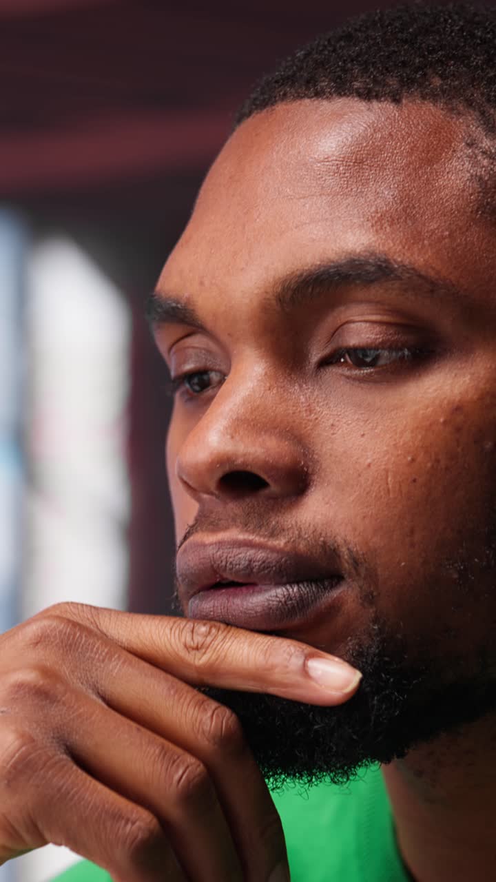 Vertical Video African american guy thinking about new ideas to increase clients numbers