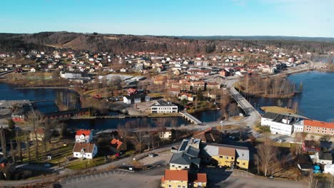 aerial drone shot flight over bengtsfors, blue sky and sunset