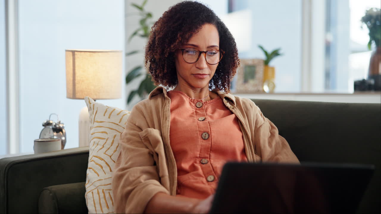 mujer trabajando desde casa en un sofá