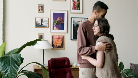 young couple hugging indoors