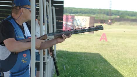 sportsman shoots from a double-barreled shotgun, a sports field for a shooting test is shooting at flying skeet