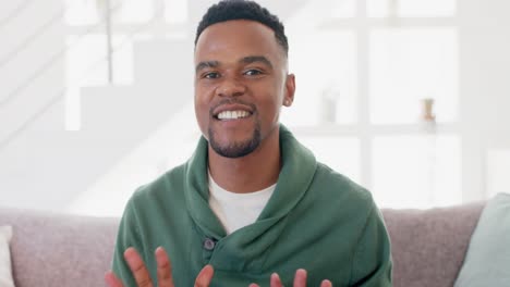 happy african american man sitting on sofa and having video call, slow motion