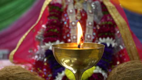 lit brass lamp with hindu goddess durga mata ji at celebration of navratri 3