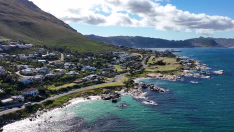 Flight-along-seaside-road-through-Simon's-Town-by-Atlantic-ocean-bay---drone