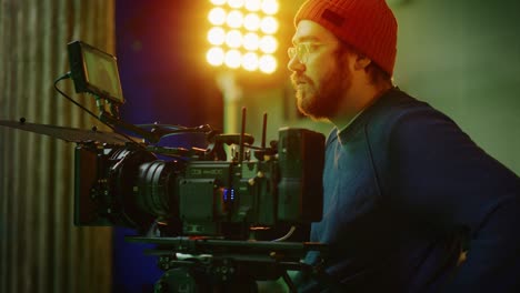 portrait of cameraman on railway trolley shooting green screne scene. professional crew on big budget filmmaking. film studio set shooting historical movie green screen scene. slow motion arc shot