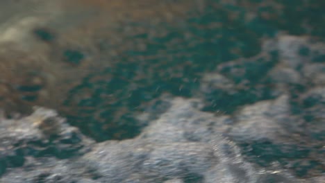 una vista de cerca del agua salpicada de olas desde el bote mientras se mueve a través del agua