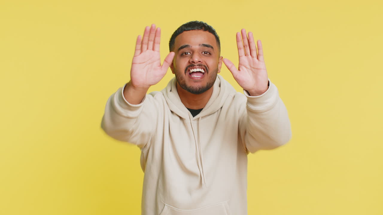 Indian man yell shout scream loud to camera promotion advertisement sale invitation greetings