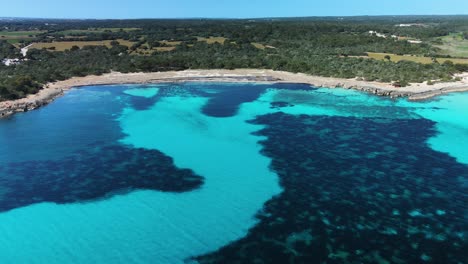 Isolated-and-secluded-little-bay-around-Son-Saura-beach-in-Menorca,-Spain