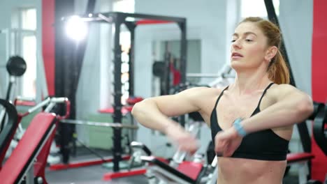fitness a muscular female athlete trains in the gym with heavy dumbbells. crossfit. slow motion 200 fps
