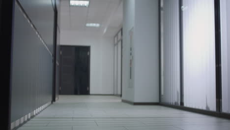 businesswoman walking down office hallway