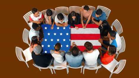 animation of flag of usa over table and happy diverse business people