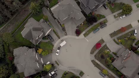 drone 4k footage over cloverdale urban housing for middle class citizens zoned city planning rotating shot above cul de sac with truck pulling a trailer