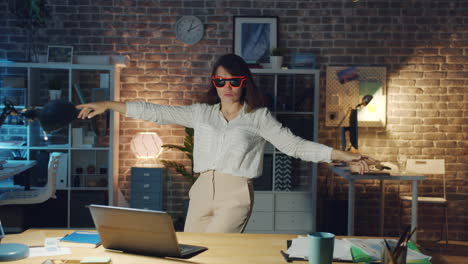 woman dancing in the office at night