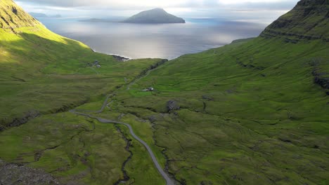 Curvy-road-on-green-seashore-in-morning