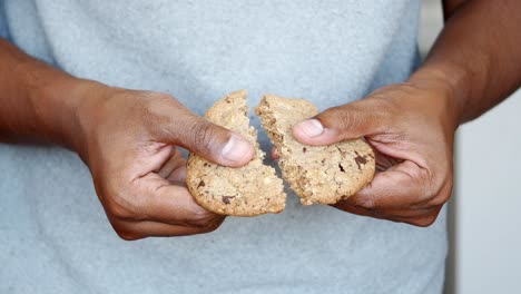 person holding a chocolate chip cookie