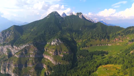 soar over the iconic jagged mountains of the dolomites, where the vibrant colors of nature blend seamlessly with dramatic rock formations in this captivating aerial video.