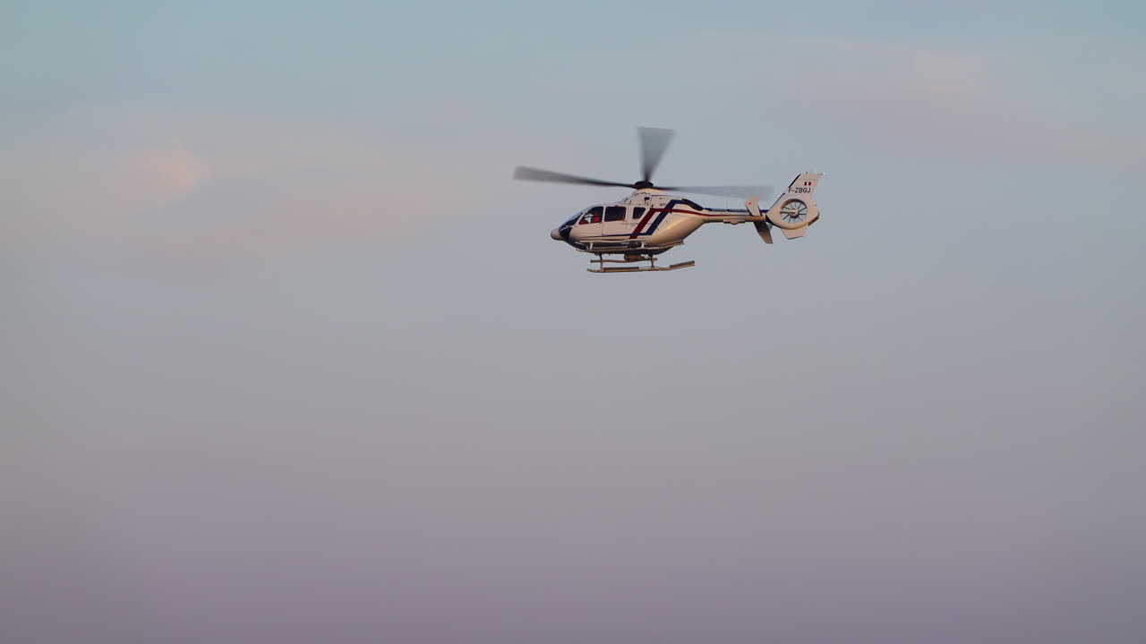 Helicopter flying in the sky in the evening in Cannes, France