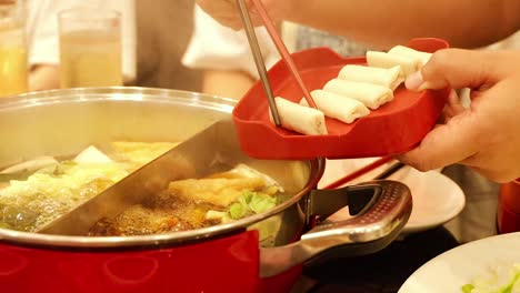 preparing hotpot with ingredients in bangkok, thailand