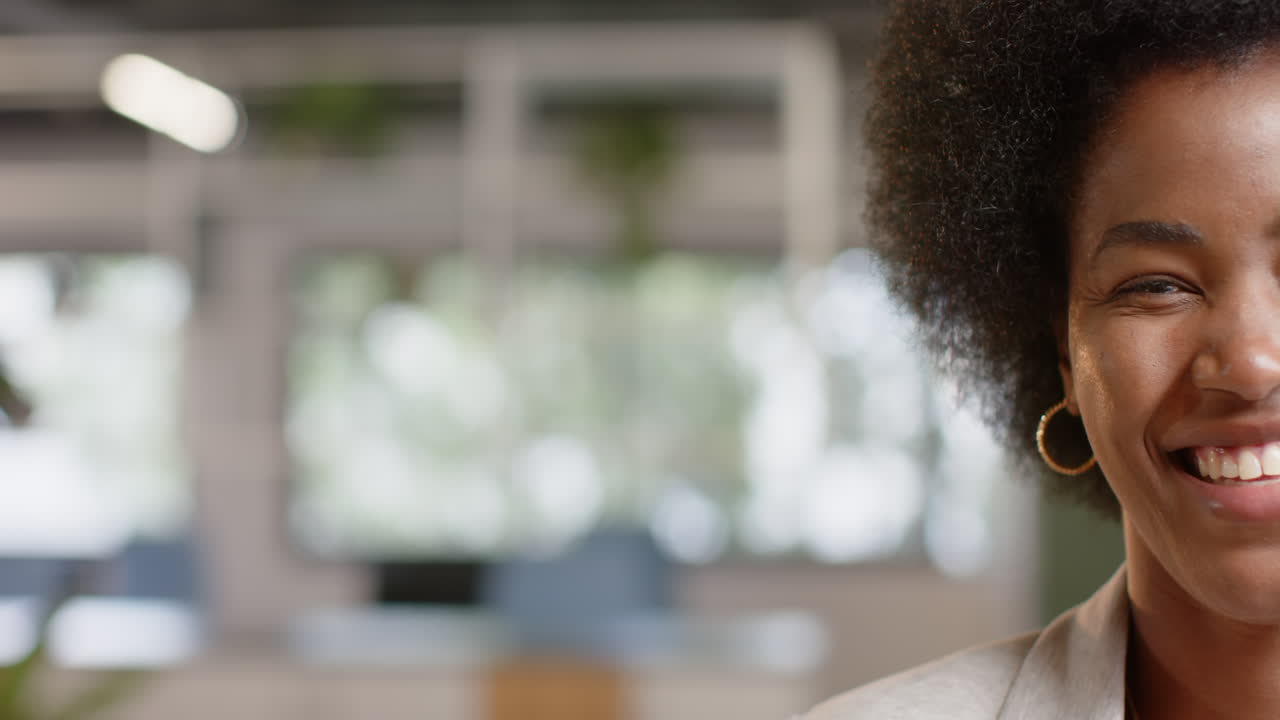 Half portrait of happy african american casual businesswoman in office with copy space, slow motion