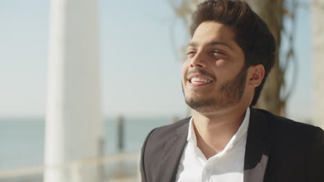 Close-up-shot-of-Arabic-man-patting-his-hair-back