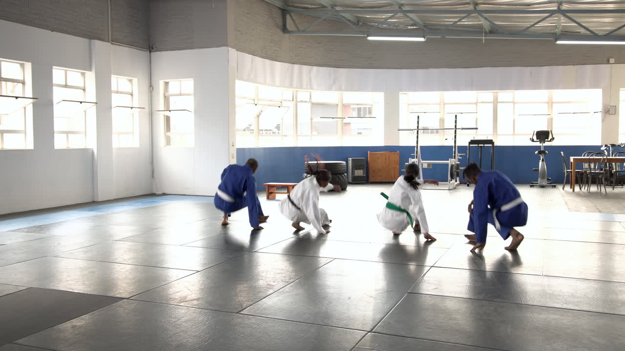 Practicing judo, group of people in martial arts uniforms in dojo