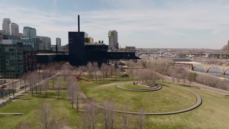 drone view of gold medal park, downtown minneapolis: serene urban oasis with scenic riverfront, cultural landmarks, and lush greenery