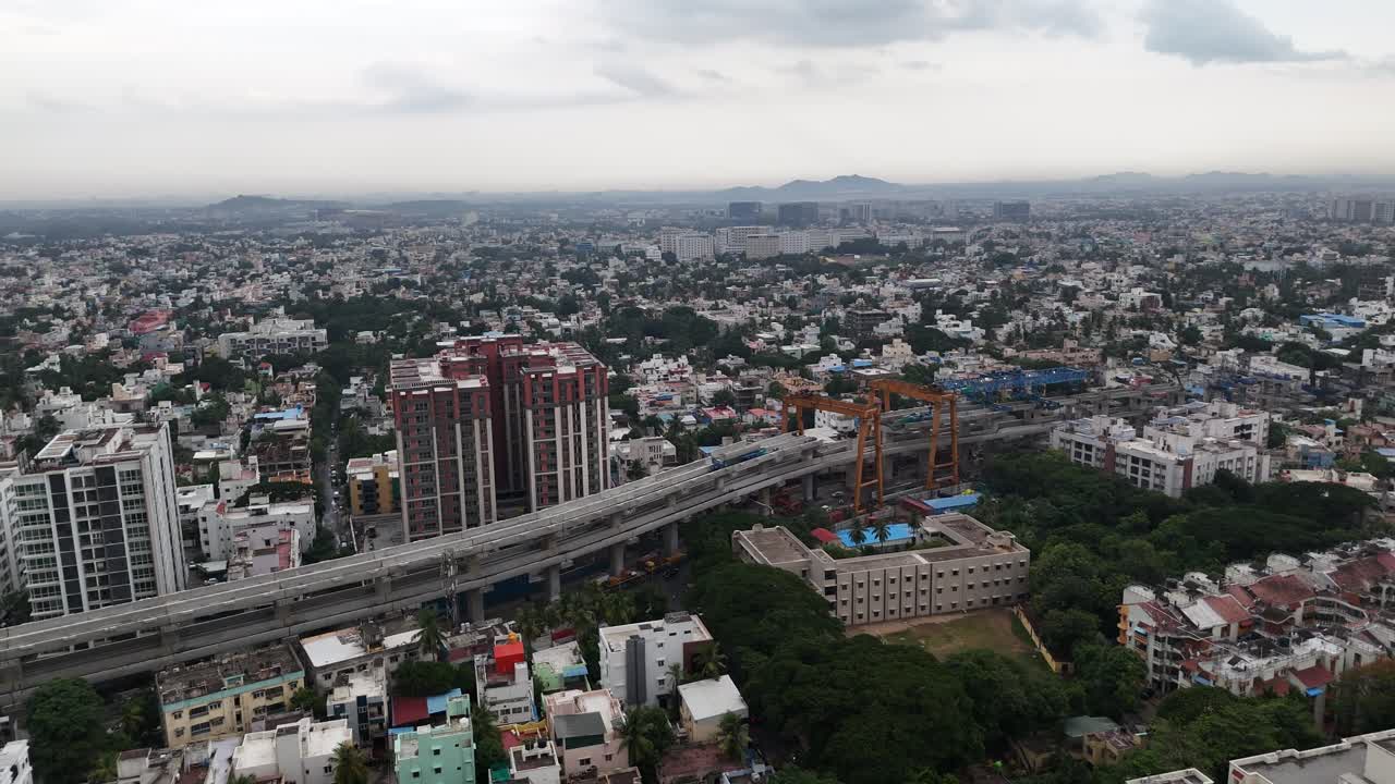 High-angle views of Chennai. The videos capture a vast urban sprawl from dusk to night, perfect for showcasing cityscapes, population density, and urban life. Rainy clouds