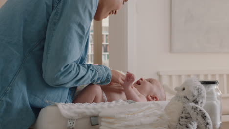 mother changing baby diaper at home caring for happy newborn infant loving mom cleaning childs nappy moisturizing skin enjoying motherhood childcare