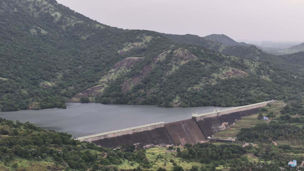 Panoramic aerial video of a mountain dam amid dense greenery and valleys near Tenkasi, showcasing the beauty of Tamil Nadu’s Western Ghats region