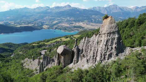 rock formation and nature landscape at lake serre poncon, french alps, france - aerial 4k circling