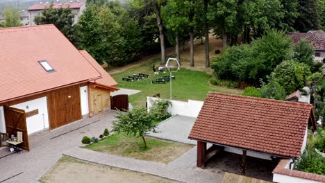 Preparing-heaxagonal-altar-and-benches-at-homestead-wedding,-aerial