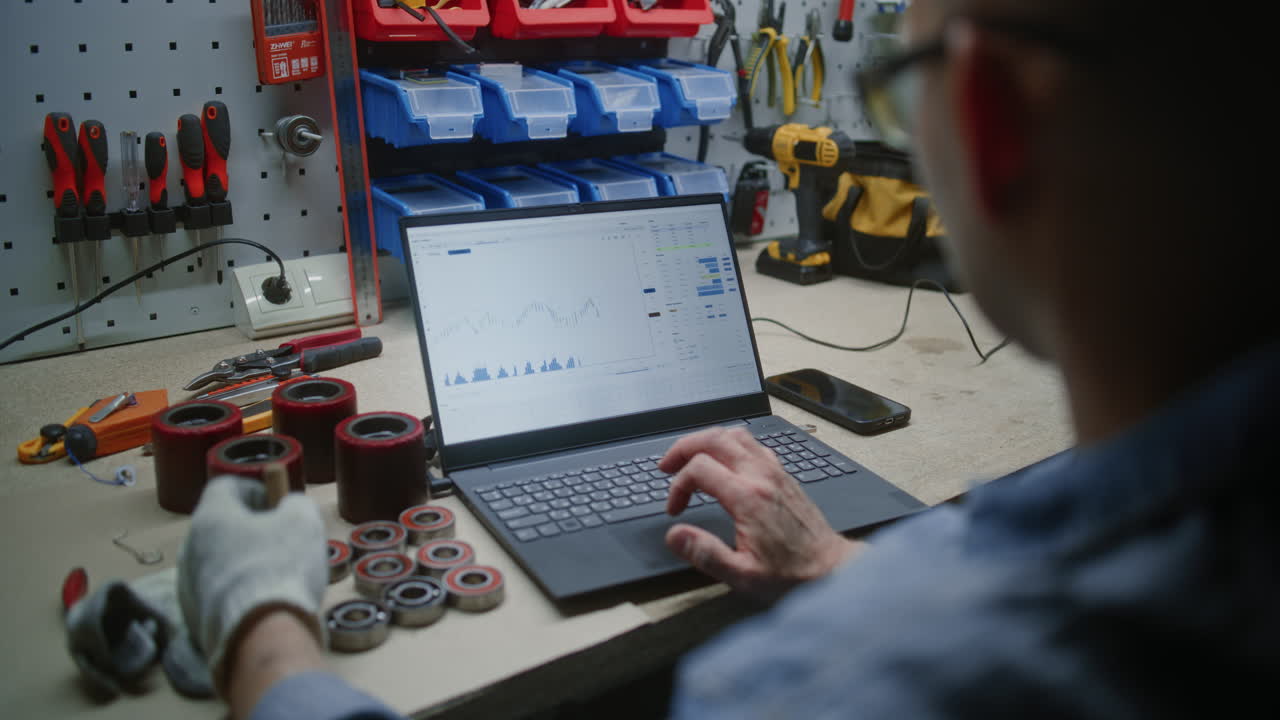 Man Checking Real-Time Stocks, Exchange Market Charts Using Laptop Computer. Employee Making Cryptocurrency Investments During Working Hours in Workshop, Combining Job with Online Trading. Close Up.