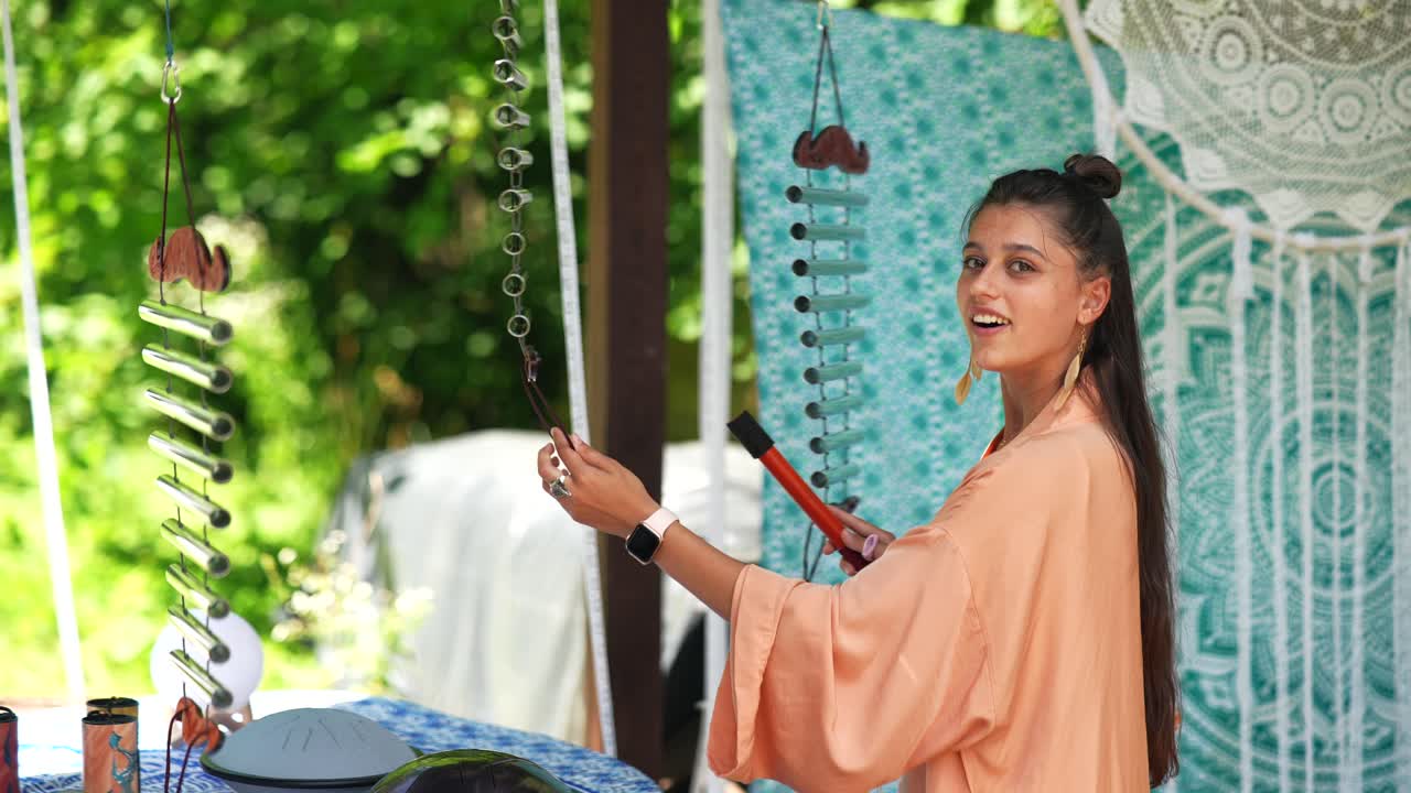 Woman playing singing bowls outdoors