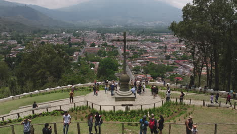 fast aerial flyover of tourists visiting the cerro de la cruz in antigua, guatemala