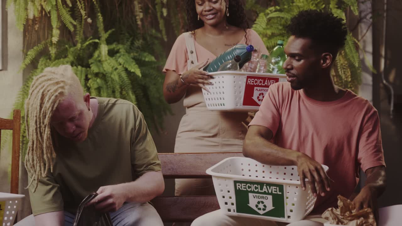 Group of Friends Actively Sorting Recyclables at Home
