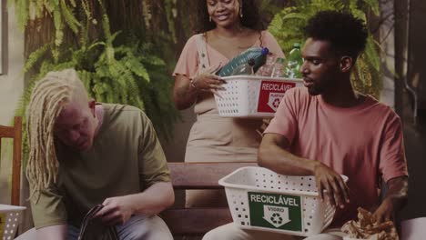 group of friends actively sorting recyclables at home