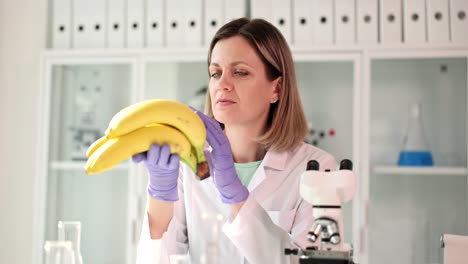a scientist examines a bunch of bananas in a laboratory