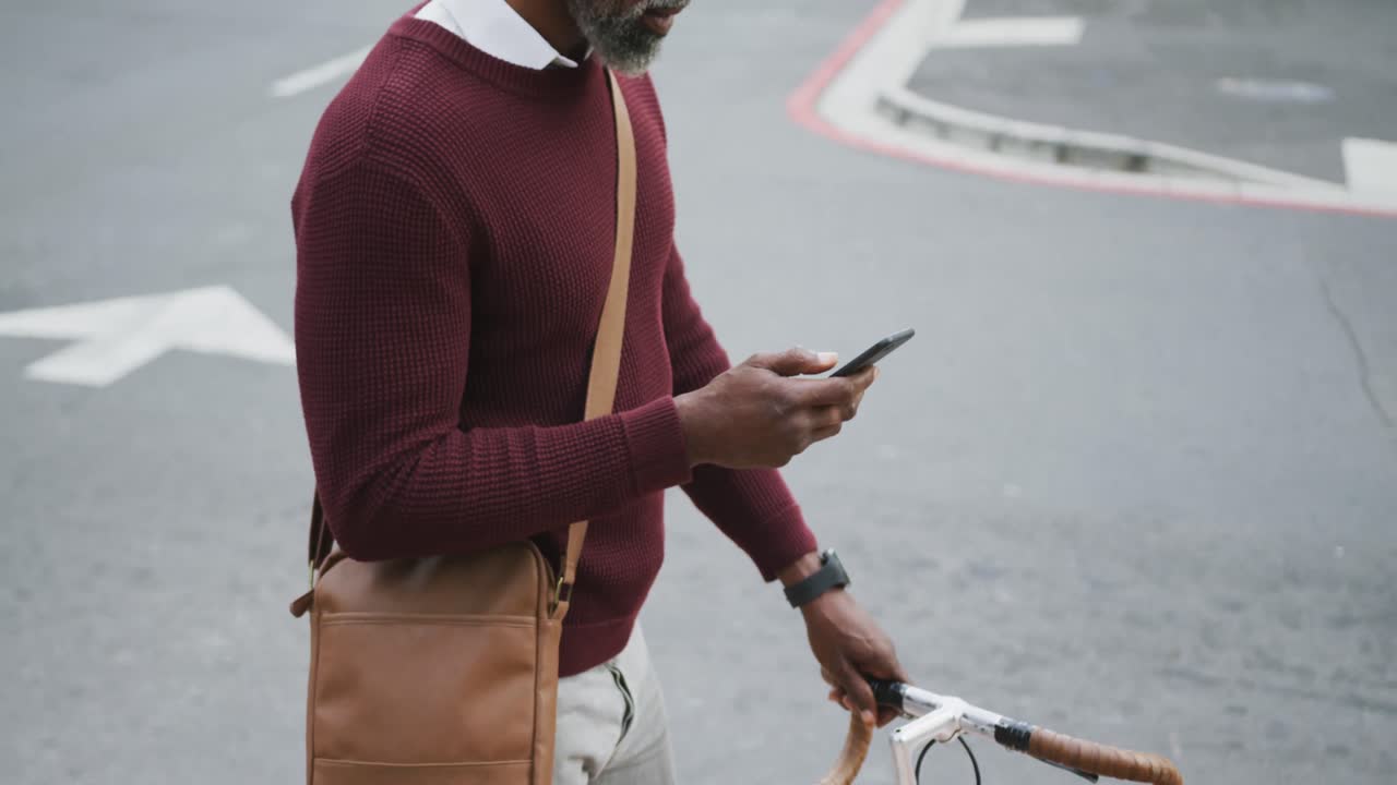 African American man using his phone in the street