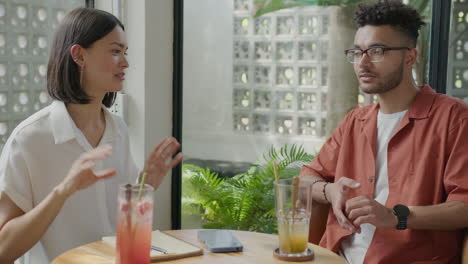 young multiracial man speaking in cafe
