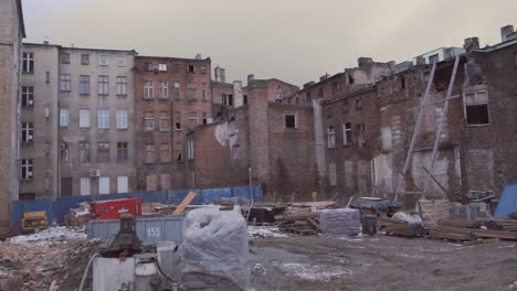 old building facades around and construction zone in the middle, area under construction