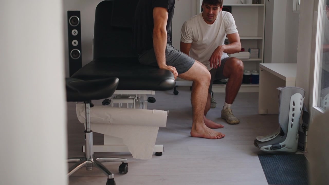Physical Therapist Examining Patient's Foot in Clinic