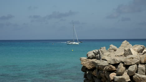 Sailboat-and-motor-boat-on-the-turquoise-mediterranean-sea-in-the-background-on-a-beautiful-summer-day-in-spain