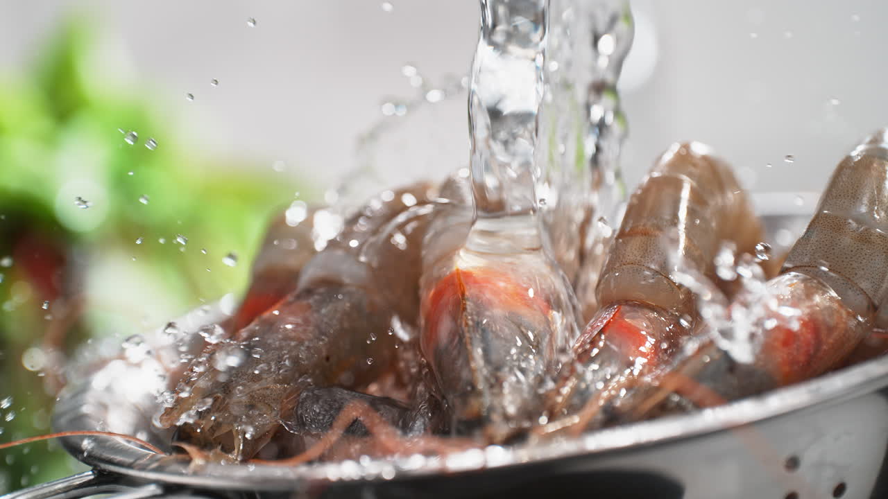 Washing Fresh Raw Prawns In A Colander Under A Stream Of Water in Slow Motion