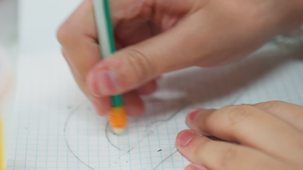 student hands drawing circles on grid paper, pencil and protractor visible, closeup of fingers guiding precise arcs, quiet classroom study session, focused homework practice, fine motor control