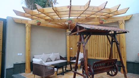 Deck-patio-outdoor-lounge-area,-establishing-shot-of-wooden-pergola-space,-nobody